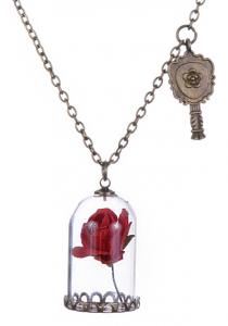Red rose under bell necklace with small bronze mirror